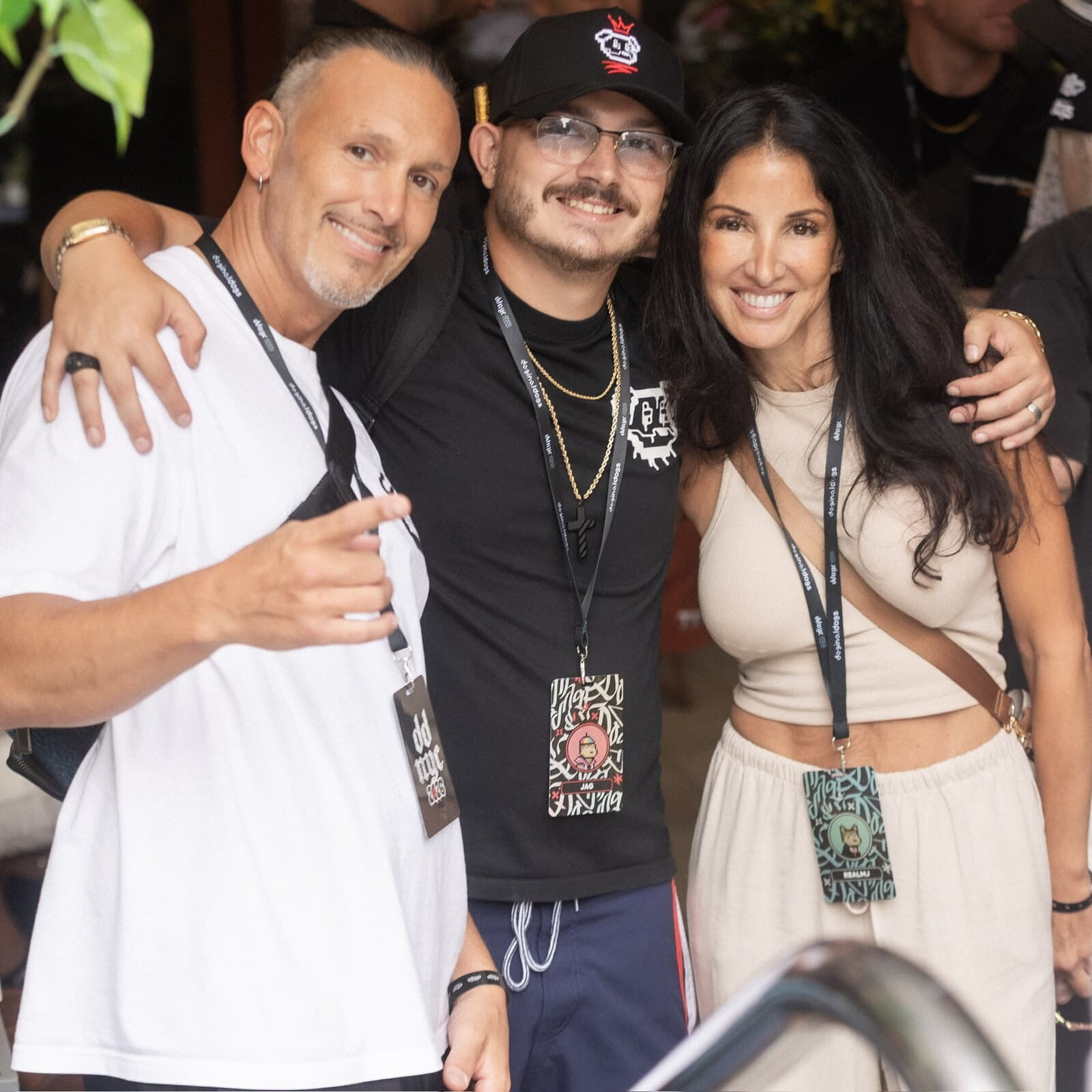 Jag (JagOBX) with two friends wearing Doginal Dogs lanyards at a community meetup